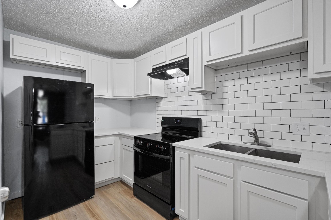 520 Lenora Drive, Unit A Taylor, TX 76574 - Photo 10 of 24 a kitchen with a sink and cabinets