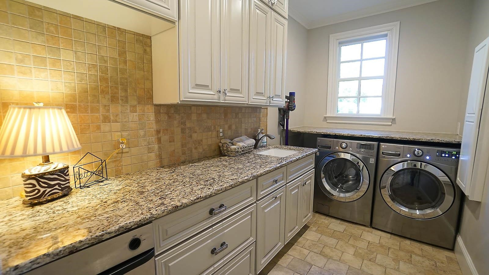 1129 Devlin Court Raleigh, NC 27614 - Photo 29 of 63 Laundry room with tons of cabinets, granite counters and tile flooring Laundry Room