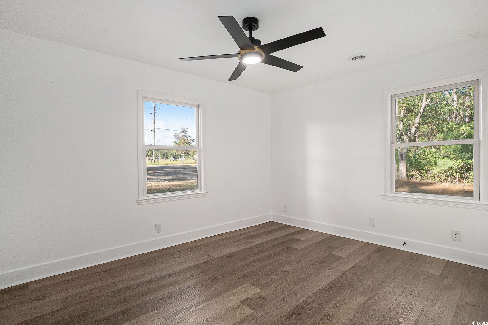 494 Ray Road Hemingway, SC 29554 - Photo 18 of 26 Spare room featuring dark wood-type flooring and healthy amount of natural light
