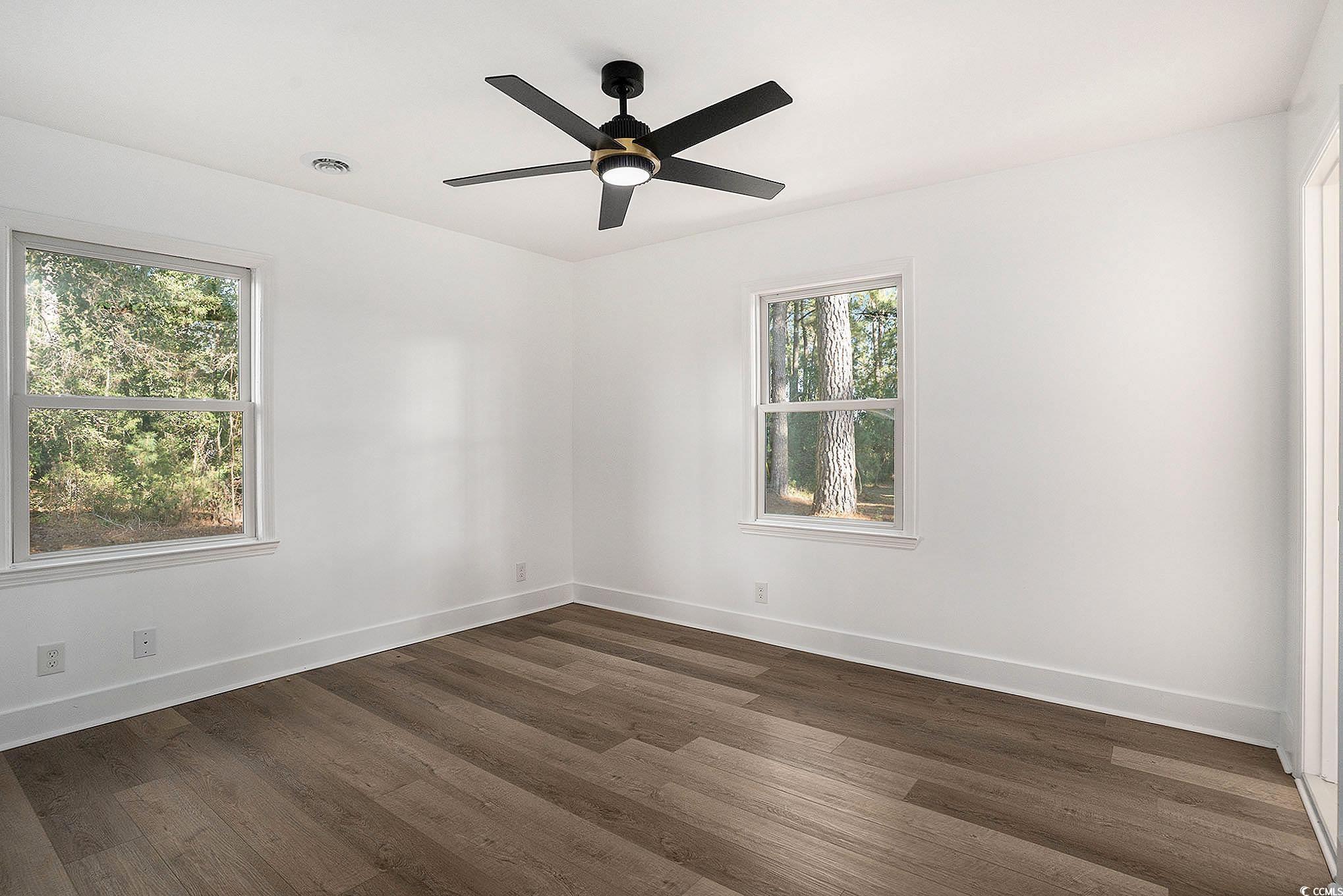 494 Ray Road Hemingway, SC 29554 - Photo 20 of 26 Empty room with dark wood-style floors and ceiling fan