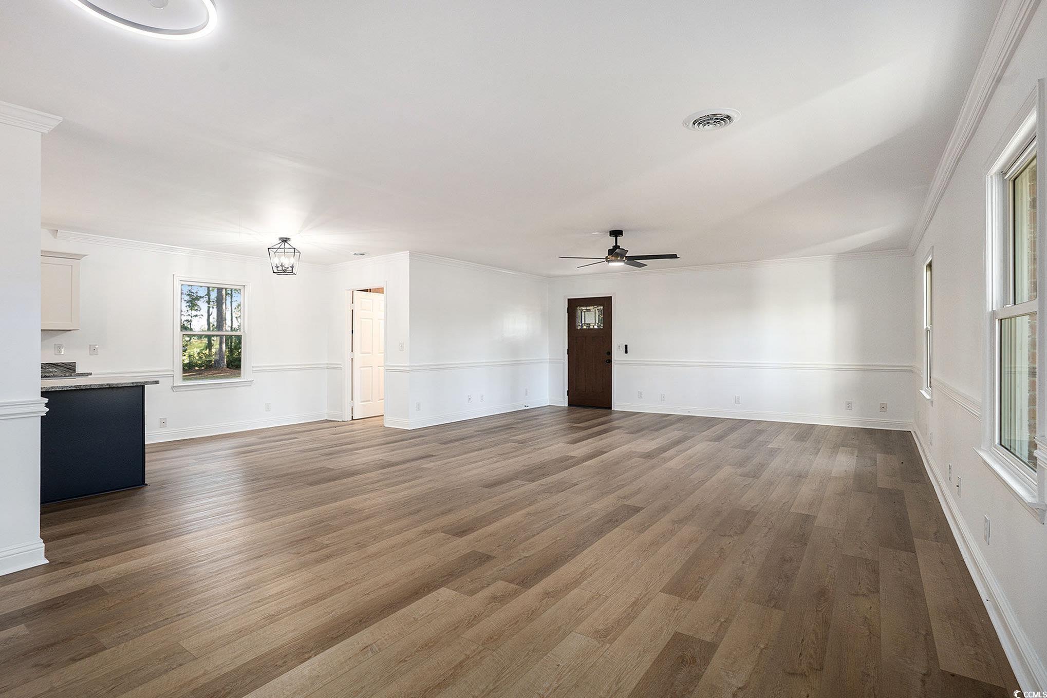 494 Ray Road Hemingway, SC 29554 - Photo 8 of 26 Unfurnished living room featuring ceiling fan, wood finished floors, and ornamental molding