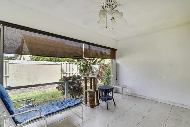a view of a porch with a table and chairs