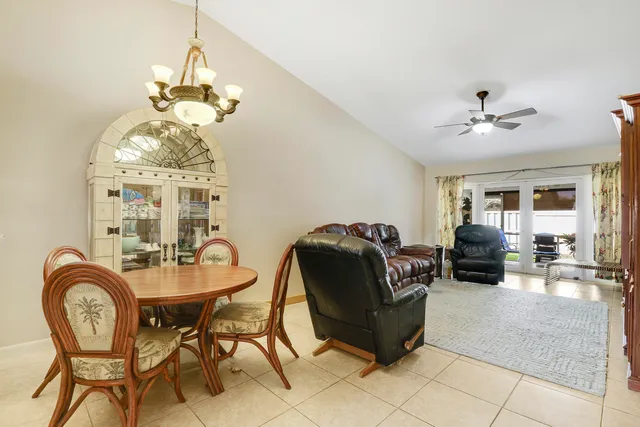 a living room with furniture a chandelier and a chandelier