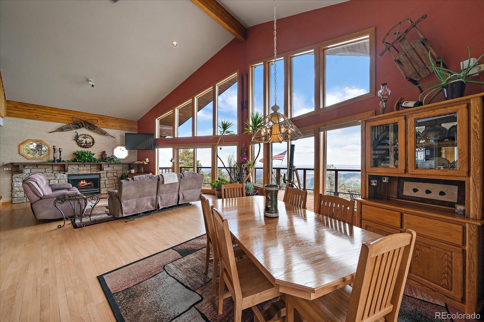 19791 Maxwell Drive Morrison, CO 80465 - Photo 11 of 50 a dining room with furniture a chandelier and wooden floor