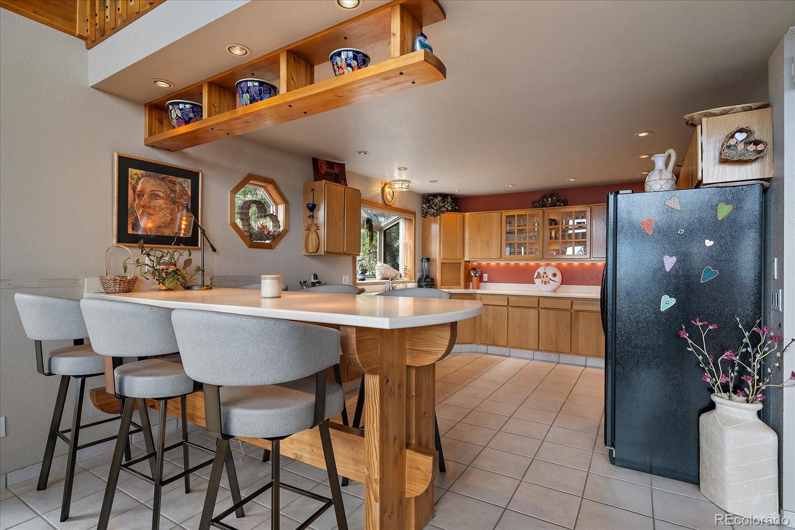 19791 Maxwell Drive Morrison, CO 80465 - Photo 13 of 50 a room with a table chairs and a kitchen view