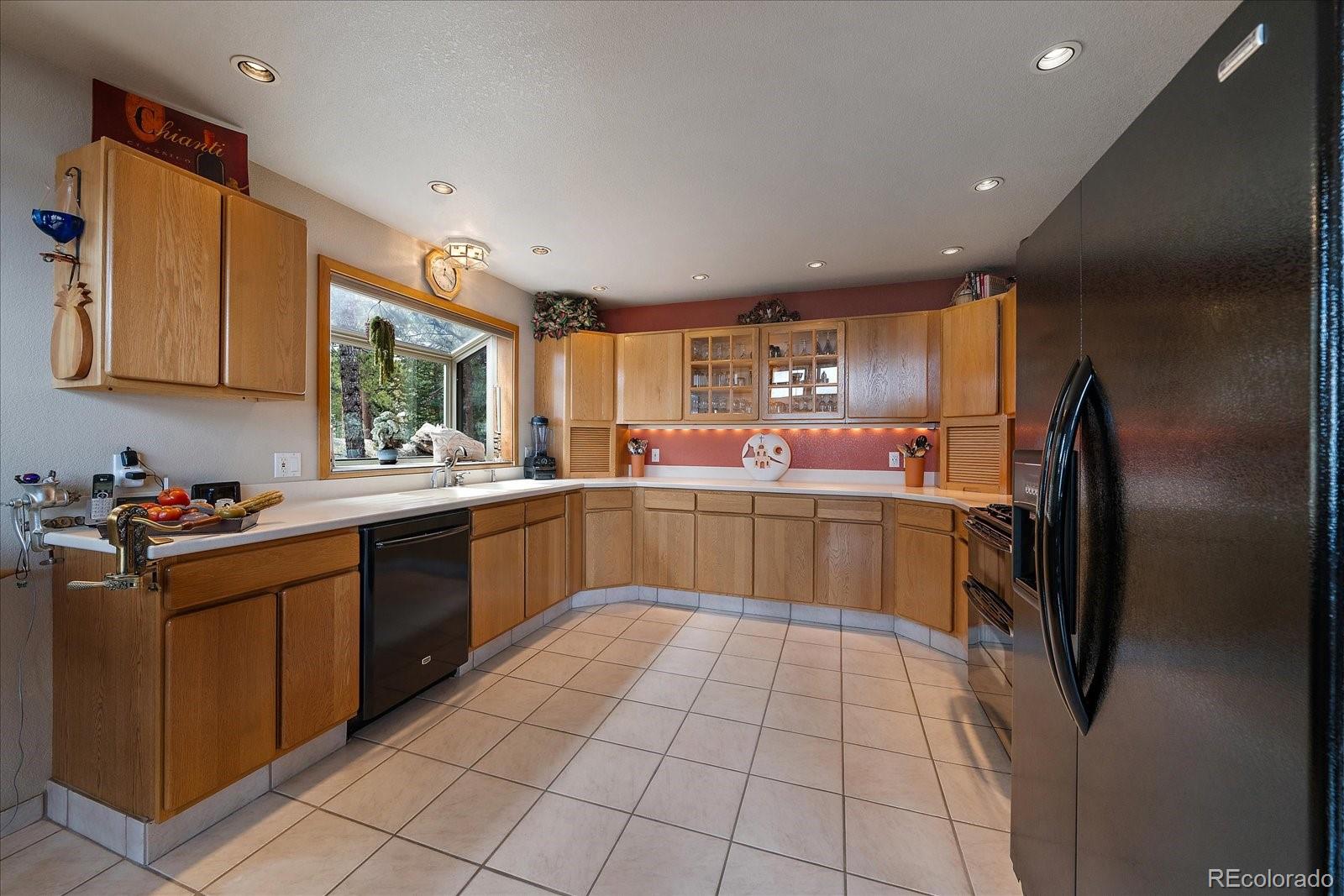 19791 Maxwell Drive Morrison, CO 80465 - Photo 14 of 50 a kitchen with a sink refrigerator and cabinets