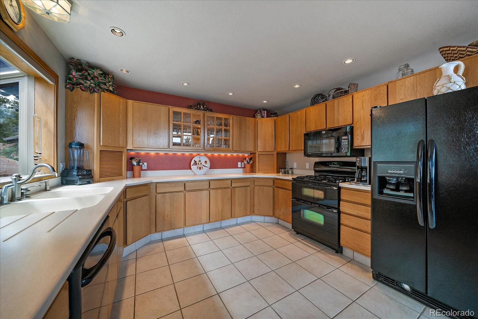 19791 Maxwell Drive Morrison, CO 80465 - Photo 15 of 50 a kitchen with a sink appliances and cabinets