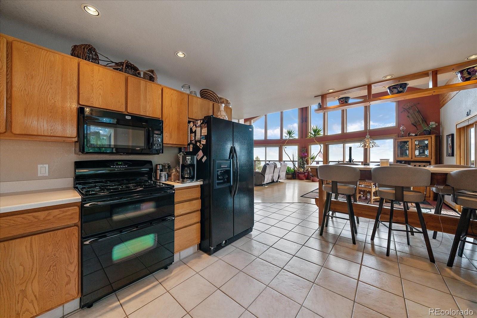 19791 Maxwell Drive Morrison, CO 80465 - Photo 16 of 50 a kitchen with stainless steel appliances granite countertop a refrigerator and a stove top oven
