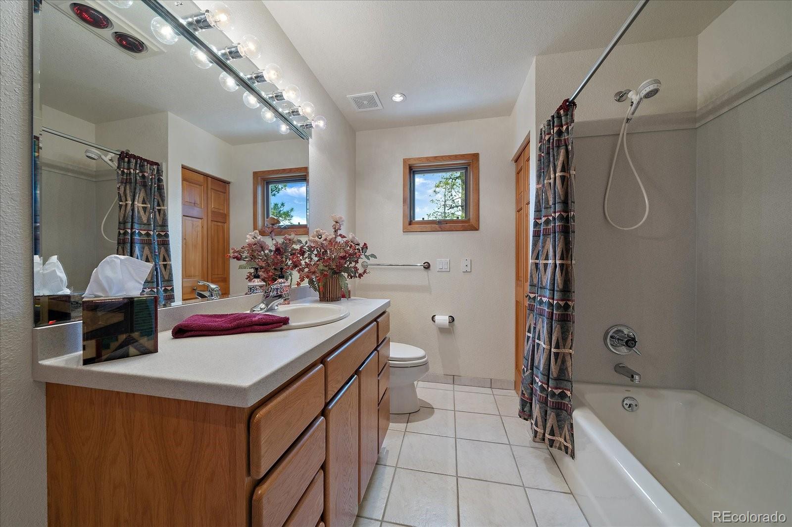 19791 Maxwell Drive Morrison, CO 80465 - Photo 19 of 50 a bathroom with a double vanity sink mirror and shower