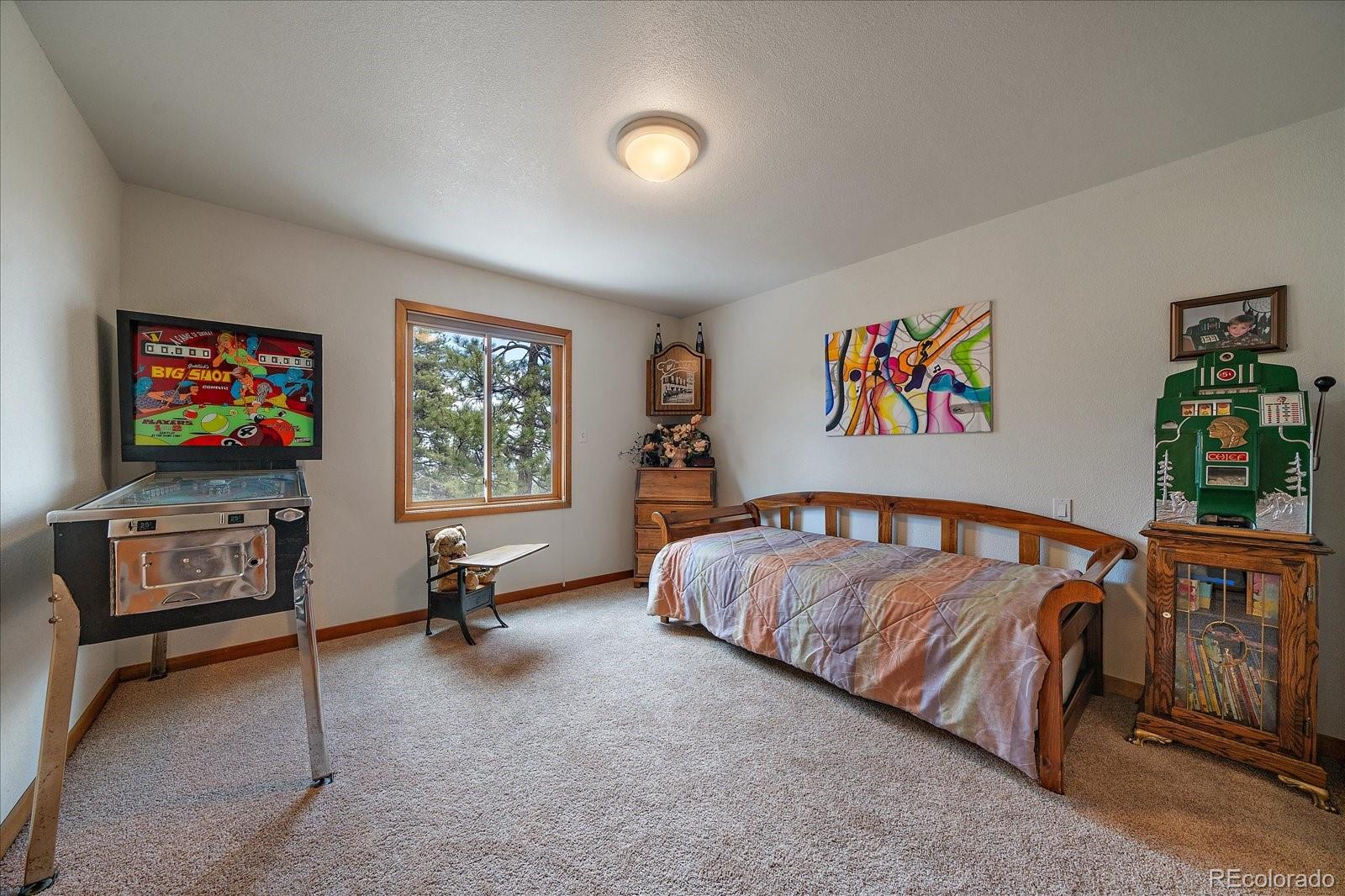 19791 Maxwell Drive Morrison, CO 80465 - Photo 20 of 50 a bedroom with furniture and a flat screen tv