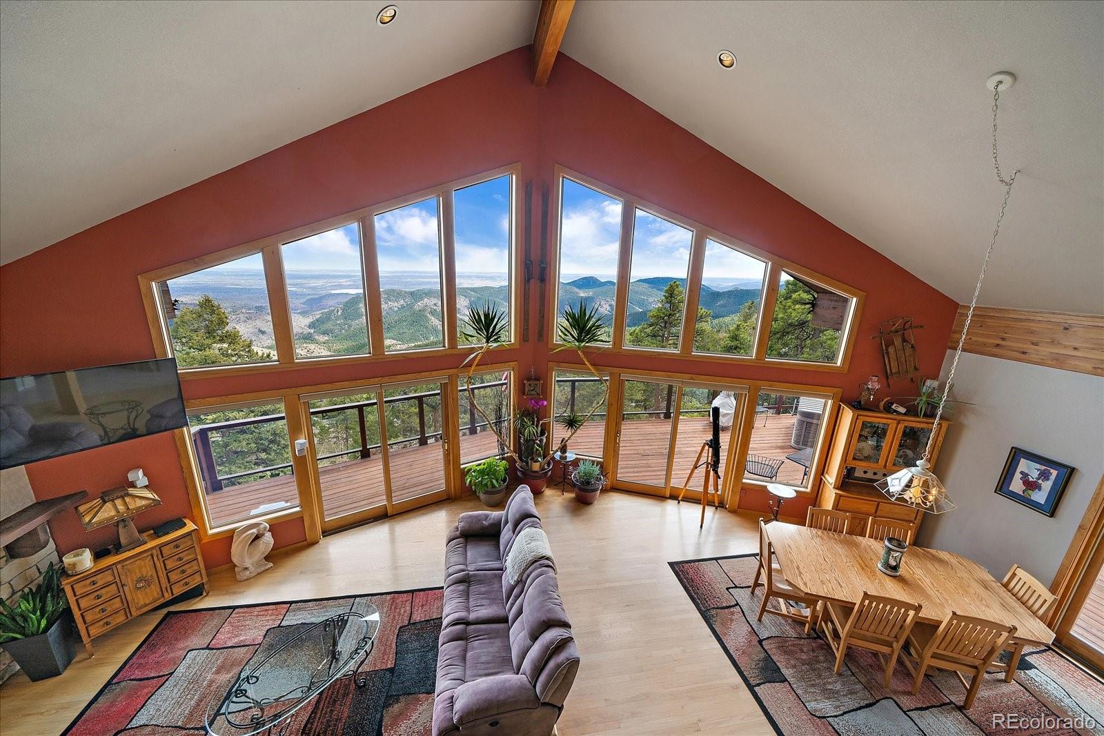 19791 Maxwell Drive Morrison, CO 80465 - Photo 23 of 50 a balcony with wooden floor and outdoor seating
