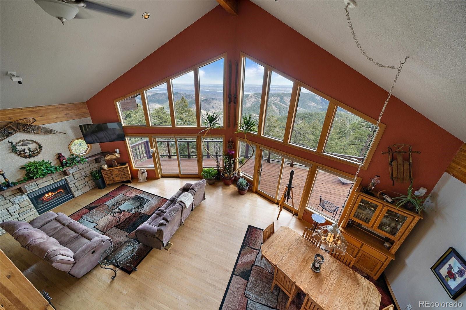 19791 Maxwell Drive Morrison, CO 80465 - Photo 24 of 50 a living room with furniture and a floor to ceiling window