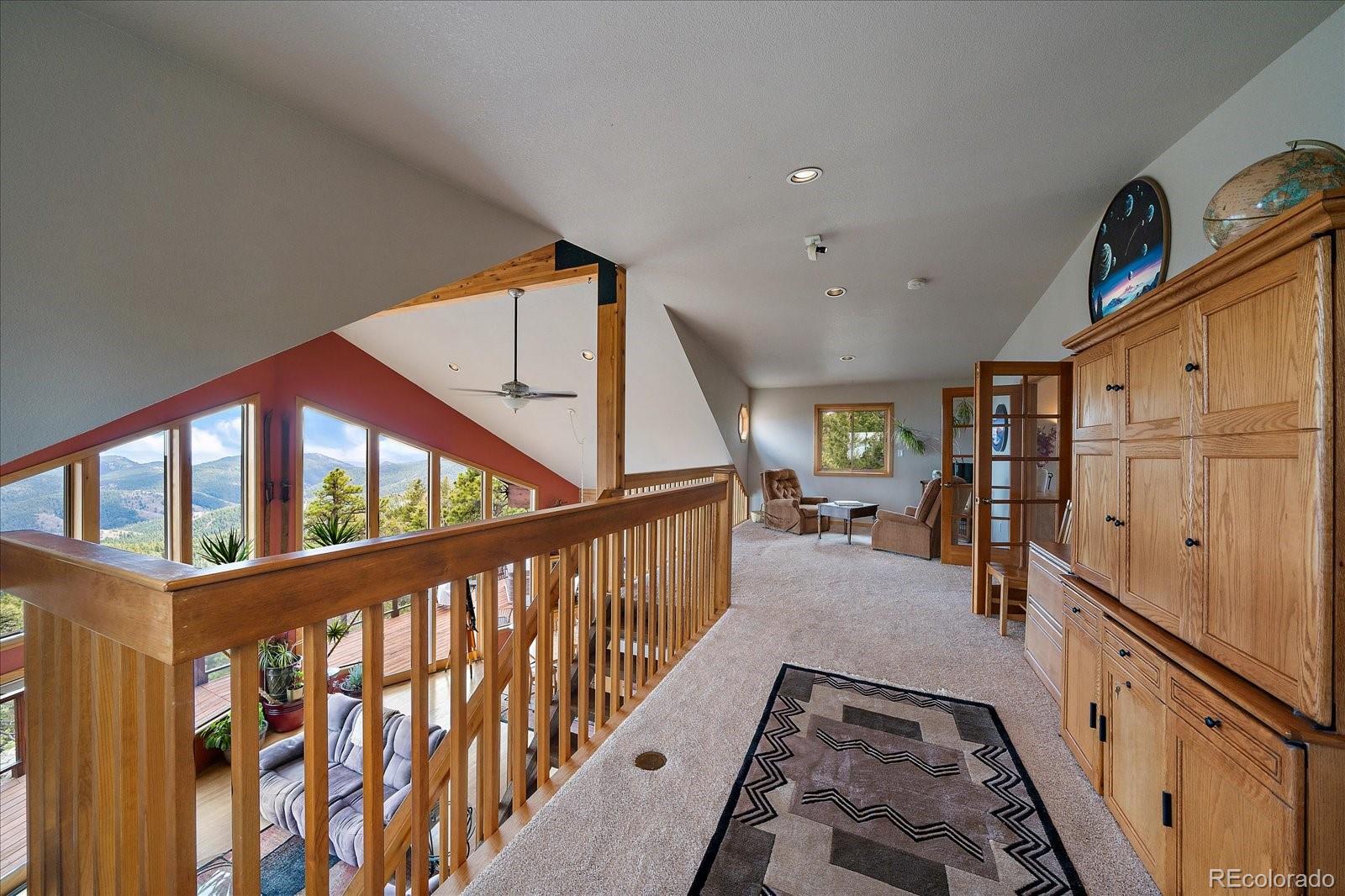 19791 Maxwell Drive Morrison, CO 80465 - Photo 26 of 50 a view of staircase with lots of frames on wall and a window