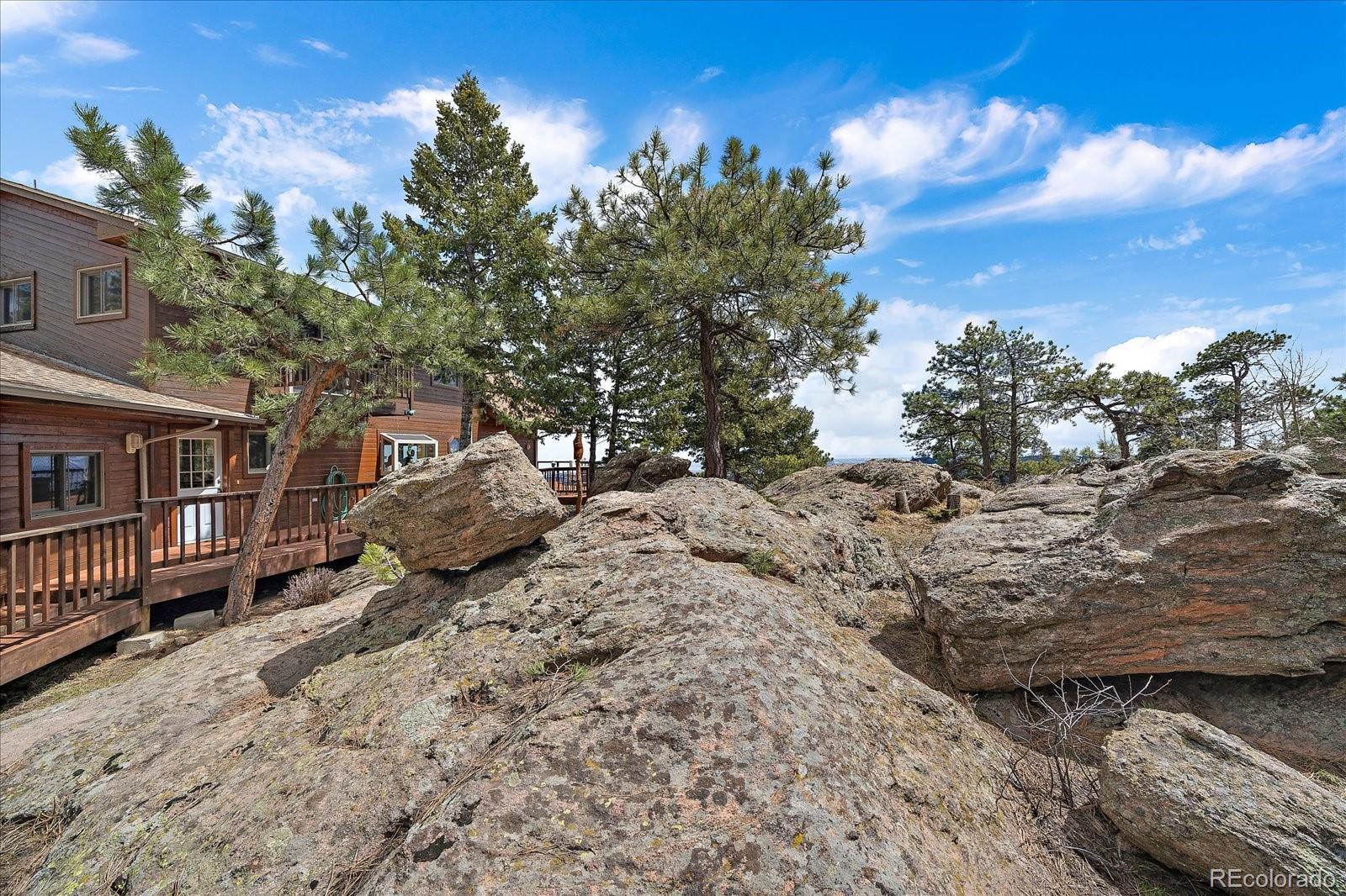19791 Maxwell Drive Morrison, CO 80465 - Photo 43 of 50 a view of a house with a snow in the yard