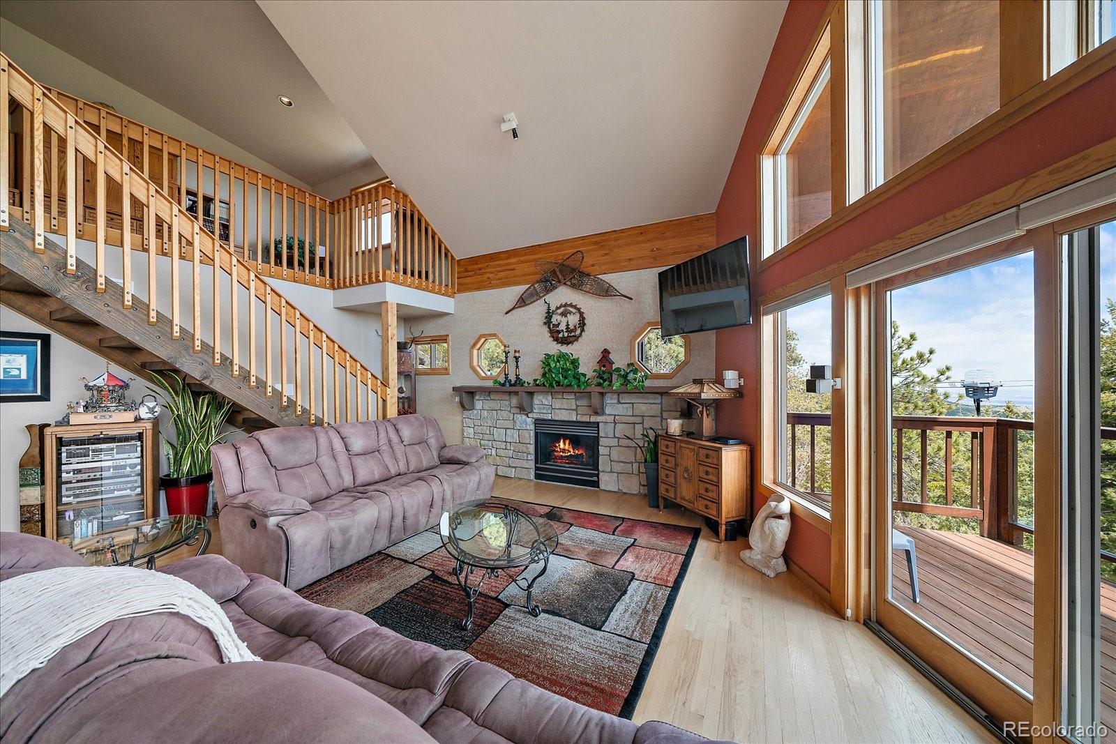 19791 Maxwell Drive Morrison, CO 80465 - Photo 8 of 50 a living room with furniture fireplace and a large window