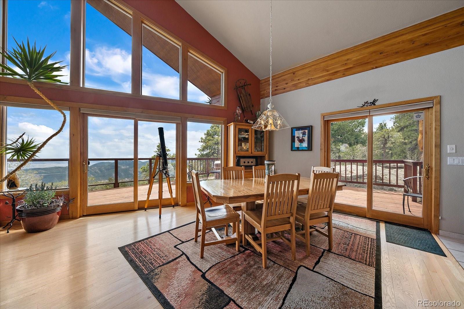 19791 Maxwell Drive Morrison, CO 80465 - Photo 10 of 50 a dining room with furniture water view and wooden floor