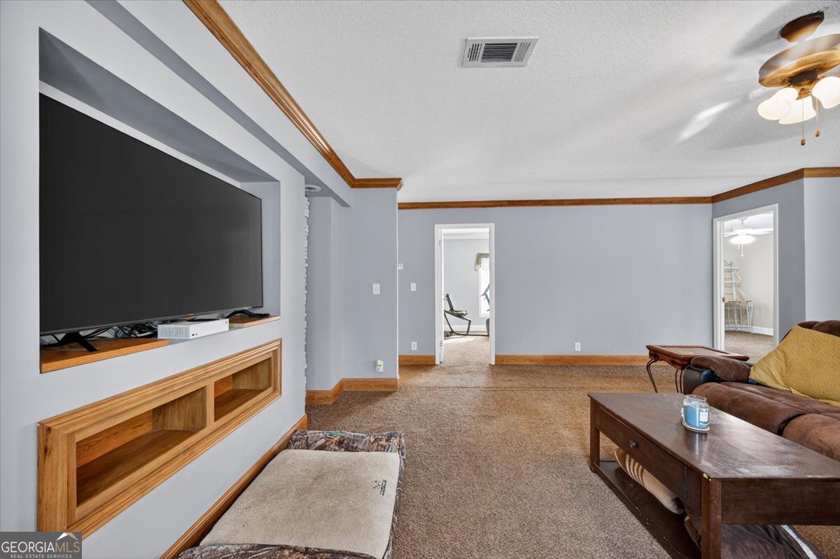 550 Damascus Church Road Haddock, GA 31033 - Photo 11 of 34 a living room with furniture and a flat screen tv