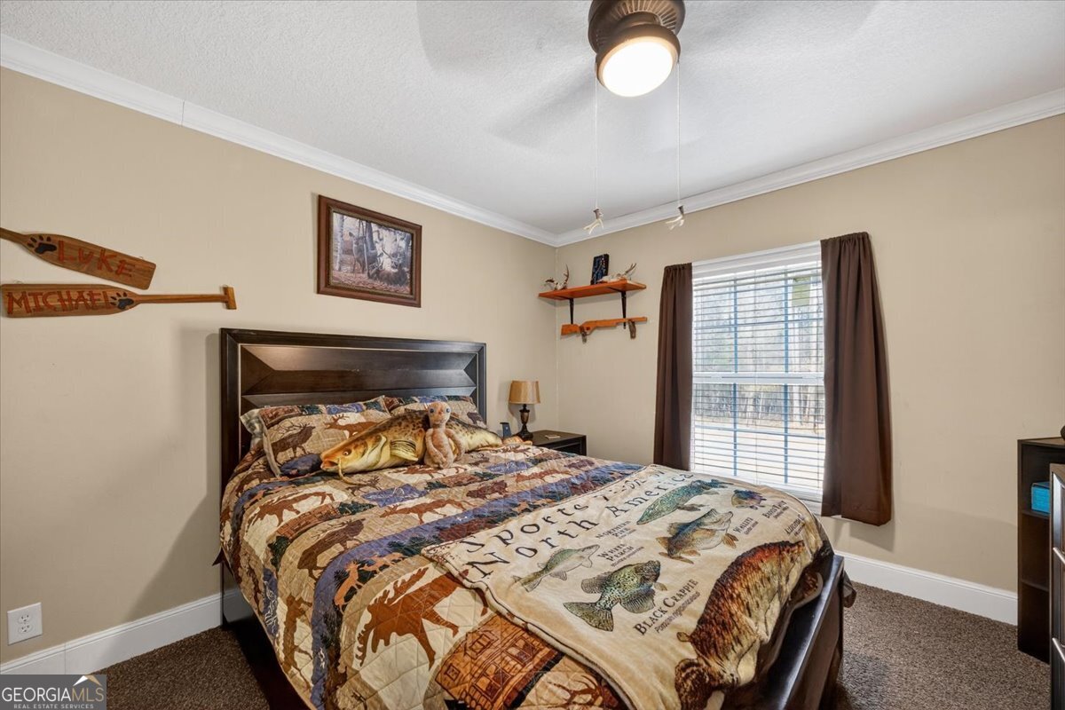 550 Damascus Church Road Haddock, GA 31033 - Photo 23 of 34 a bedroom with a bed and a large window