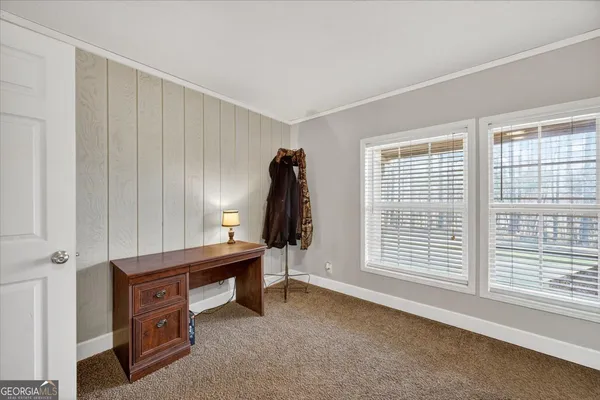 a view of a workspace with furniture and a window