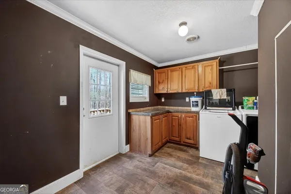 a kitchen with a refrigerator and a stove top oven