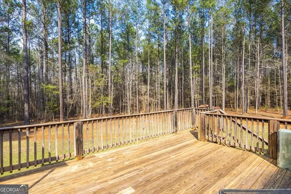 a view of a balcony with a floor to ceiling window and wooden fence