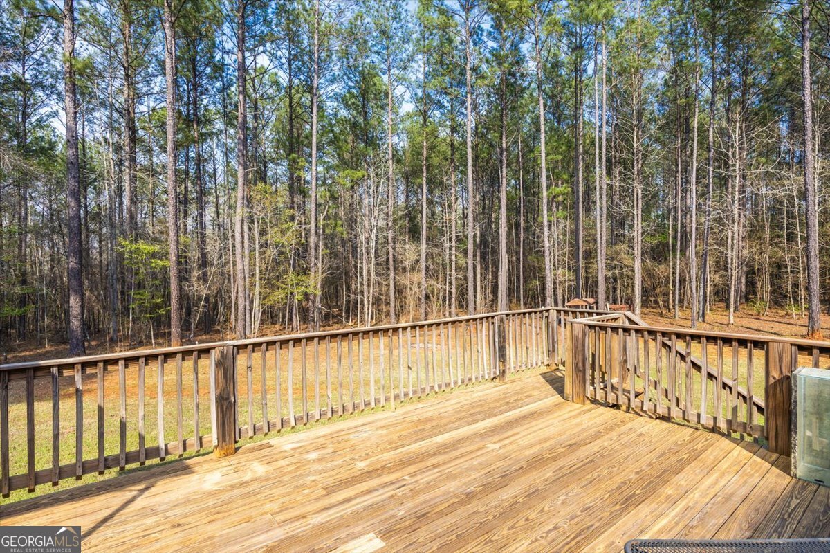 550 Damascus Church Road Haddock, GA 31033 - Photo 28 of 34 a view of a balcony with a floor to ceiling window and wooden fence