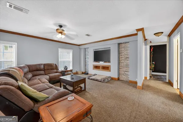 a living room with furniture and a flat screen tv