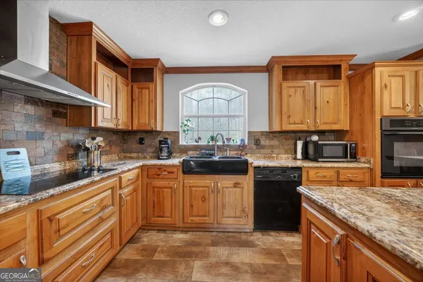 a kitchen with stainless steel appliances granite countertop a stove sink and cabinets