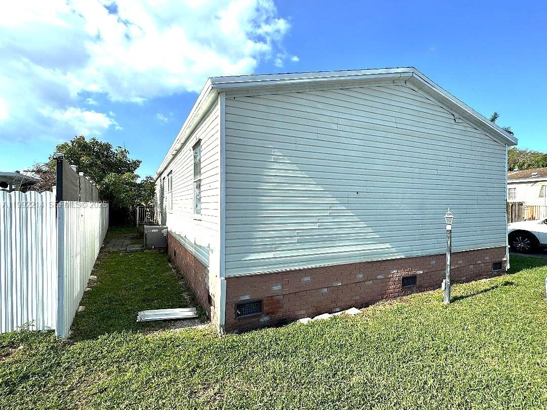 220 Northeast 12th Avenue, Unit 182 Homestead, FL 33030 - Photo 3 of 9 a front view of a house with garden