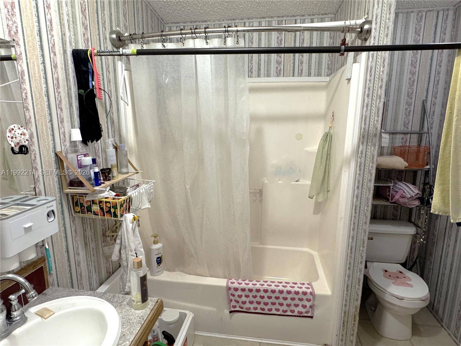 220 Northeast 12th Avenue, Unit 182 Homestead, FL 33030 - Photo 8 of 9 a bathroom with a toilet and a shower