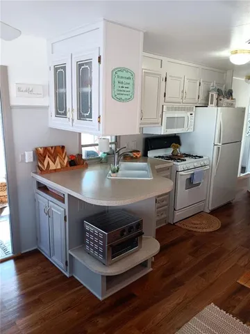 a kitchen with stainless steel appliances a stove a sink and a refrigerator