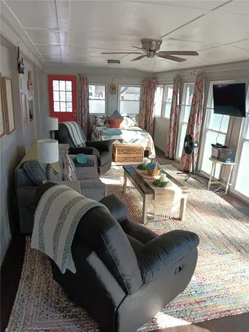 a living room with furniture and a chandelier