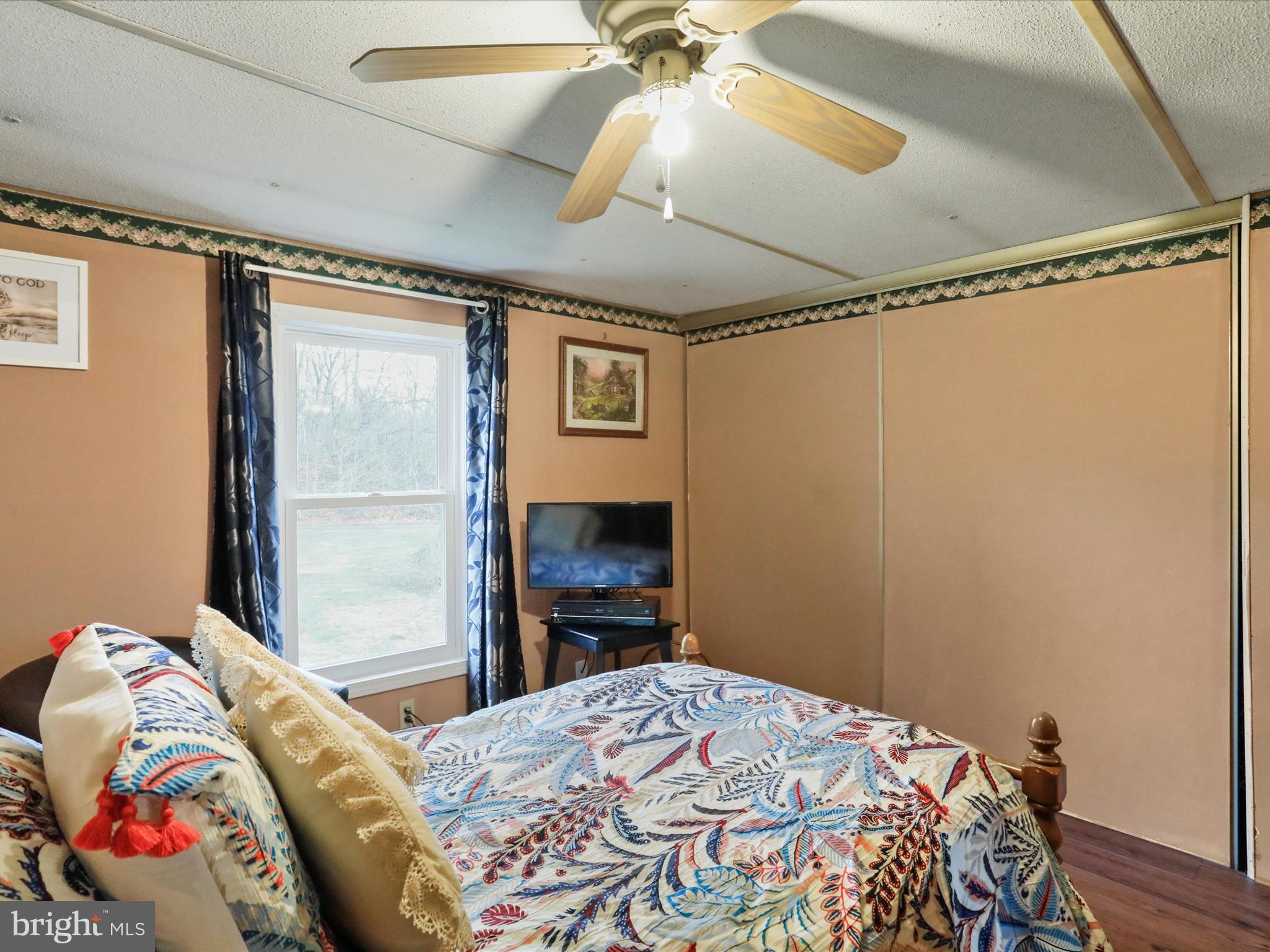 11713 Ernstville Road Big Pool, MD 21711 - Photo 13 of 47 a bedroom with a bed and a chandelier