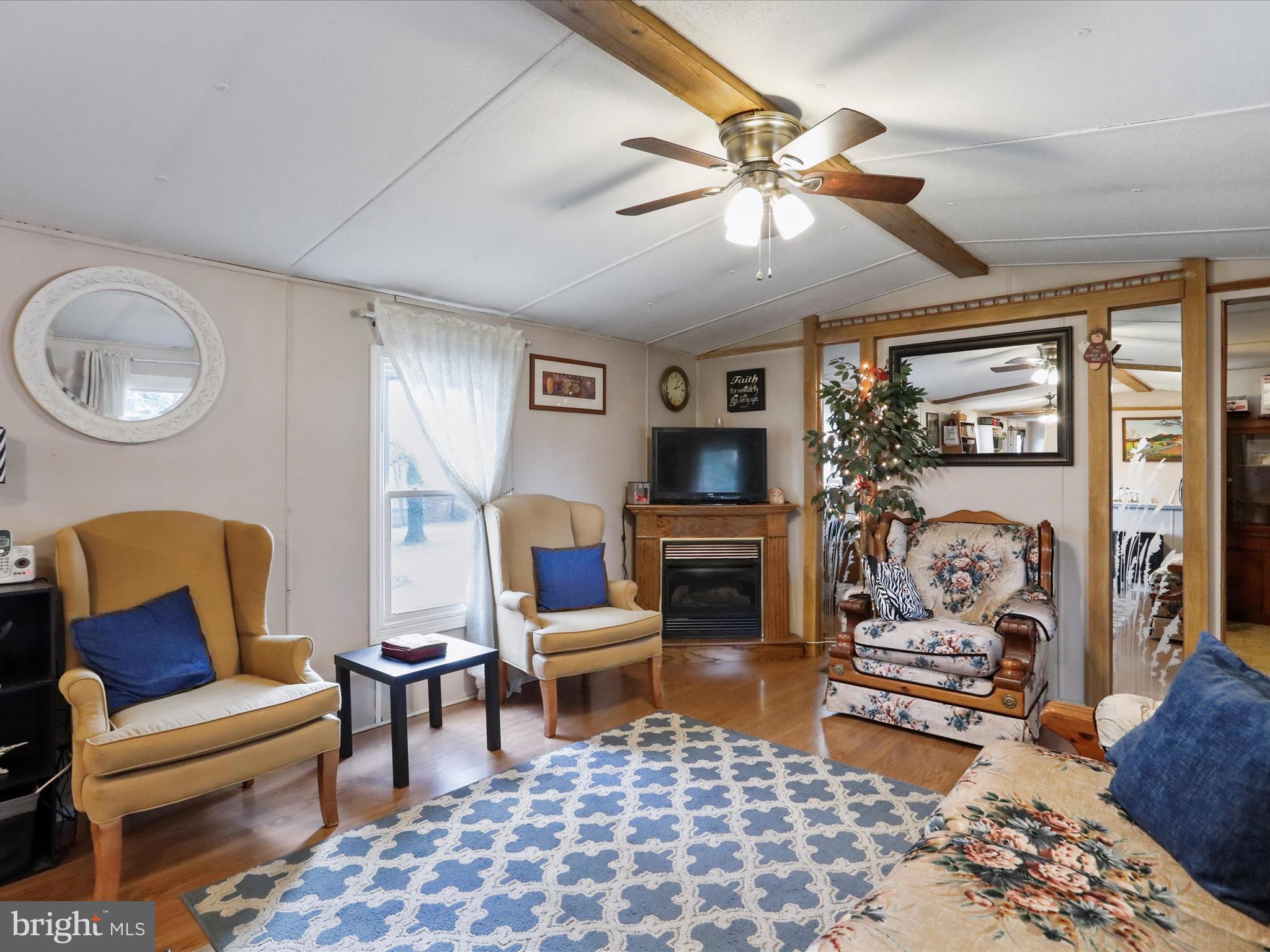 11713 Ernstville Road Big Pool, MD 21711 - Photo 5 of 47 a living room with furniture a rug and a flat screen tv
