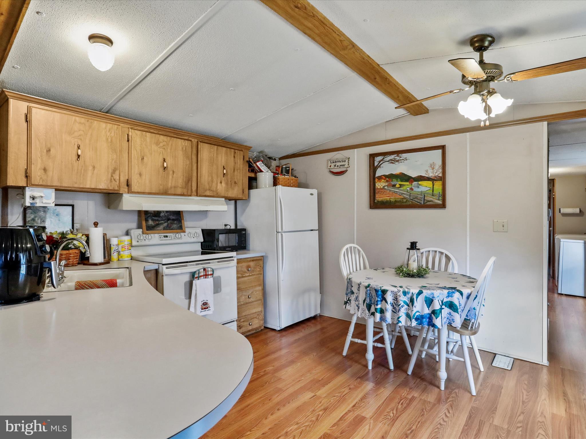 11713 Ernstville Road Big Pool, MD 21711 - Photo 9 of 47 a kitchen with stainless steel appliances granite countertop a dining table chairs refrigerator and microwave