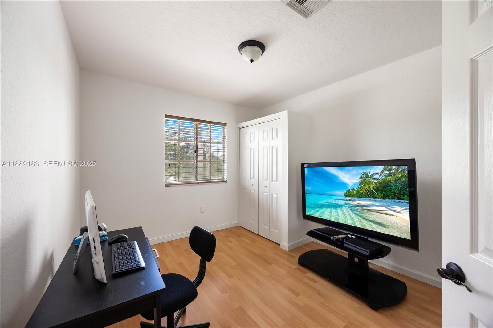 14254 Southwest 272nd Street Homestead, FL 33032 - Photo 13 of 25 a view of a workspace with furniture and screen