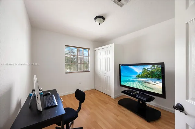 a view of a workspace with furniture and screen