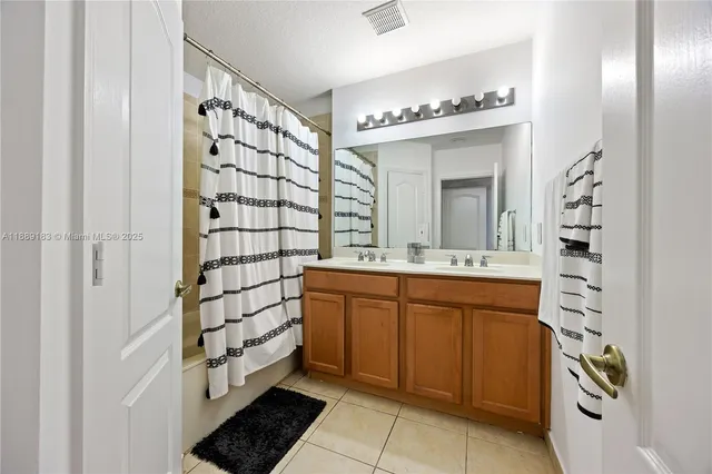 a bathroom with a sink a mirror and a shower