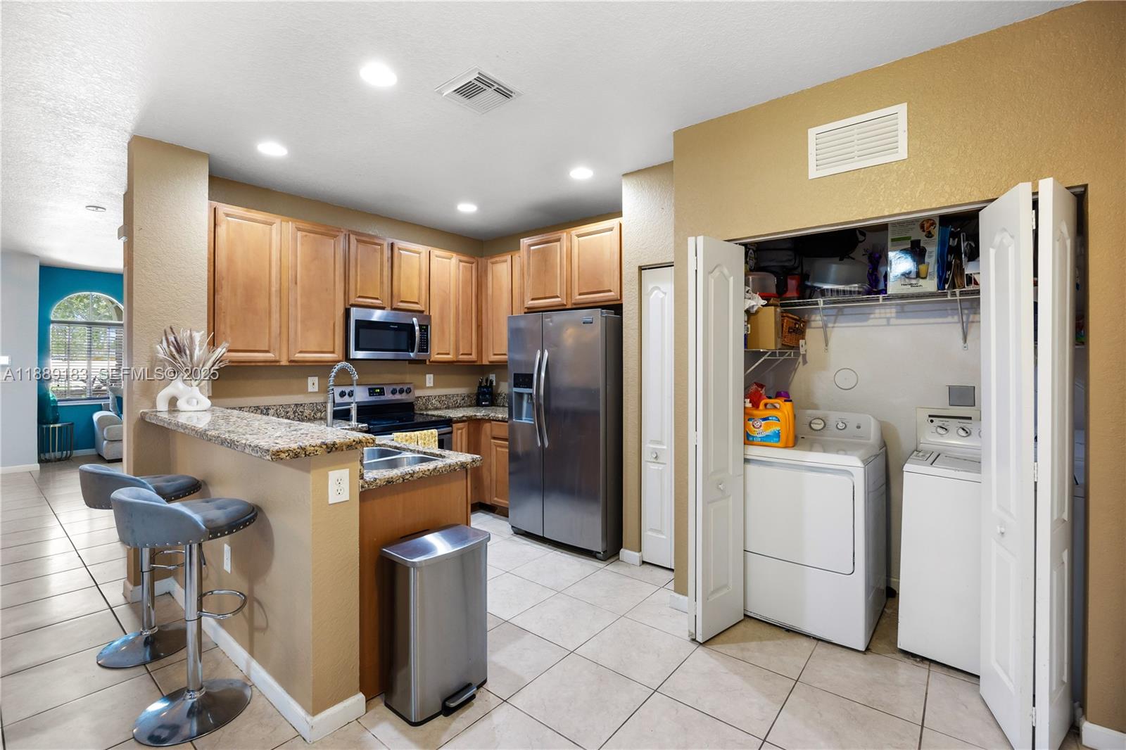 14254 Southwest 272nd Street Homestead, FL 33032 - Photo 17 of 25 a kitchen with refrigerator and washer