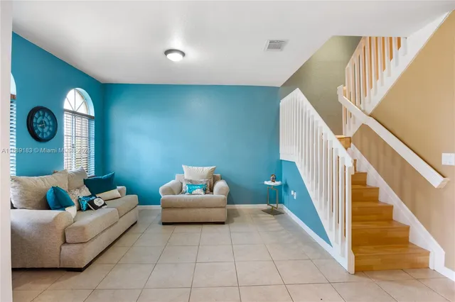a living room with furniture and a rug