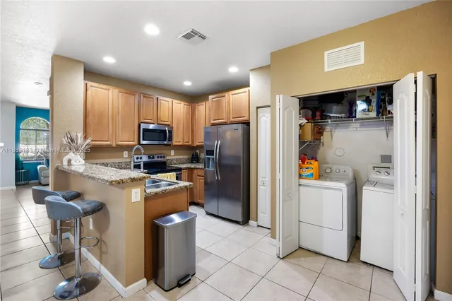 a kitchen with refrigerator and washer