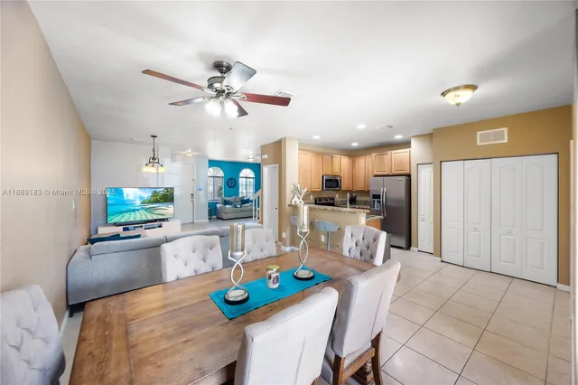 a view of a dining room with furniture and a kitchen view