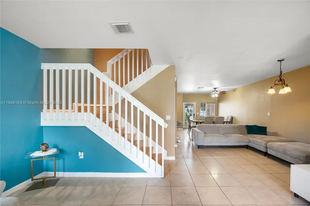 a living room with furniture and a dining table
