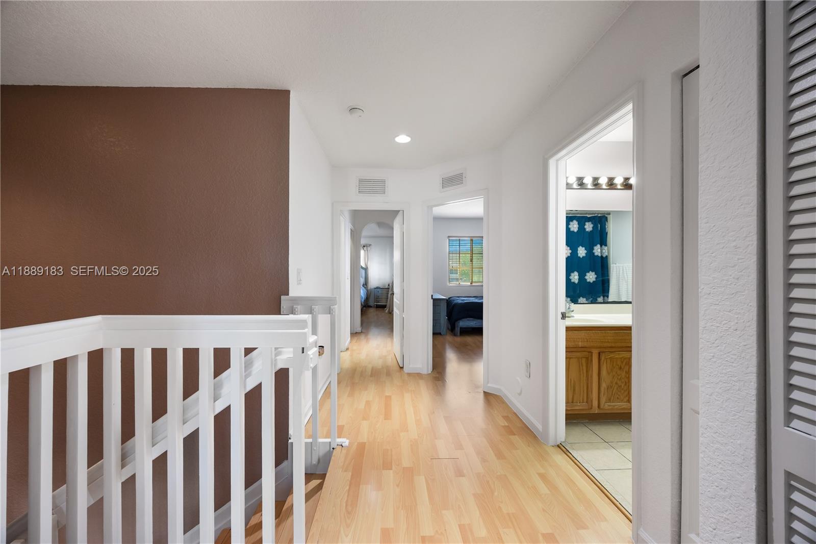 14254 Southwest 272nd Street Homestead, FL 33032 - Photo 9 of 25 a view of a hallway with wooden floor and staircase