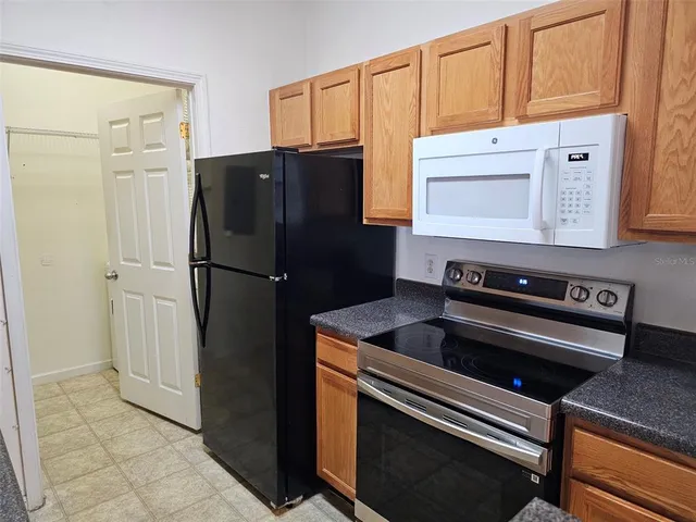 a kitchen with metallic refrigerator and cabinets