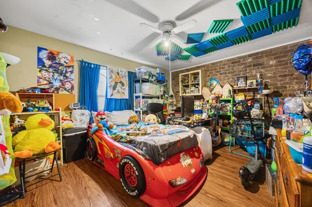 a bed room with furniture and a flat screen tv