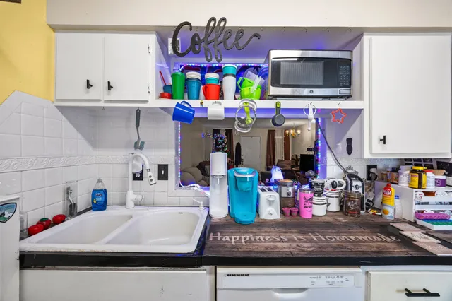 a kitchen with a microwave a stove and cabinets