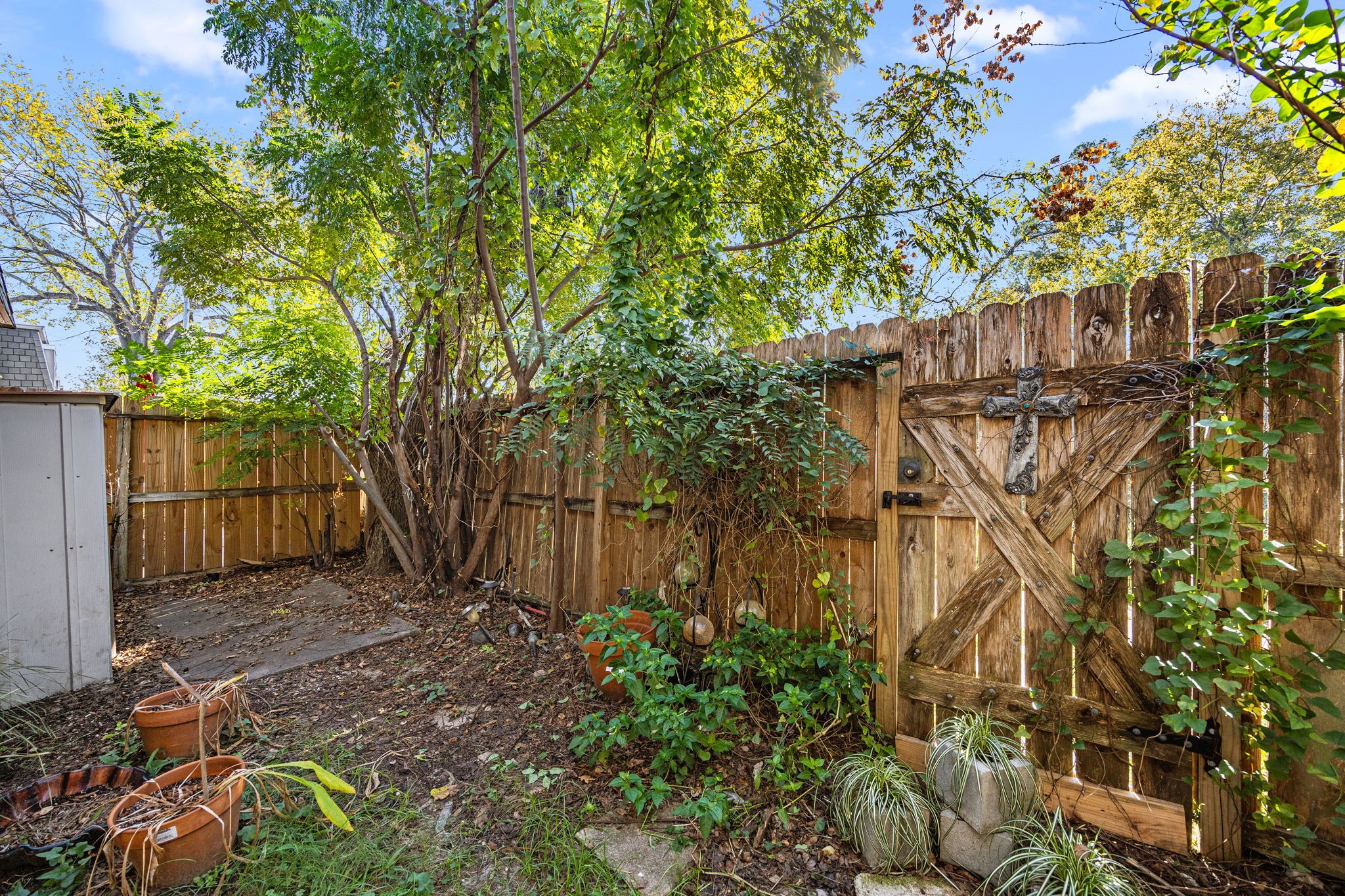 9023 Gaylord Drive, Unit 101 Houston, TX 77024 - Photo 18 of 23 a view of a yard with plants and wooden fence
