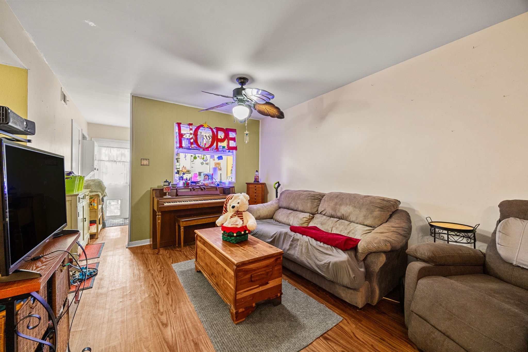 9023 Gaylord Drive, Unit 101 Houston, TX 77024 - Photo 3 of 23 a living room with furniture a flat screen tv and a wall painting