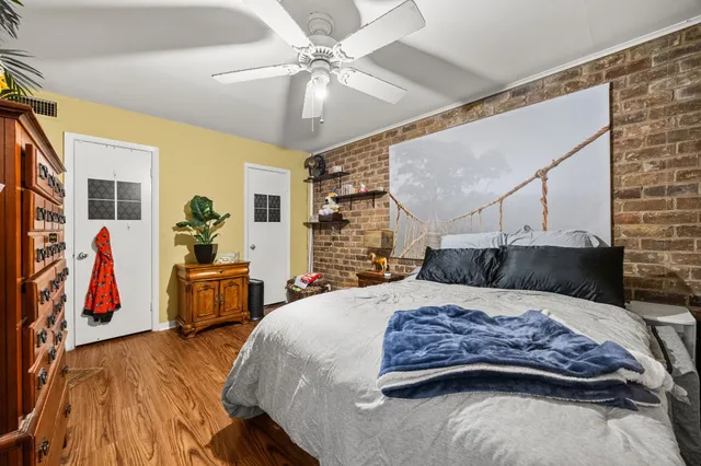 a bedroom with a large bed and a chandelier